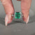 Asscher gemstone ring emerald bezel round diamond band.
