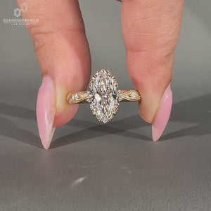 Marquise diamond ring round side stones milgrain set.

