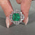 Asscher cut emerald ring nature cluster twisted shank set.
