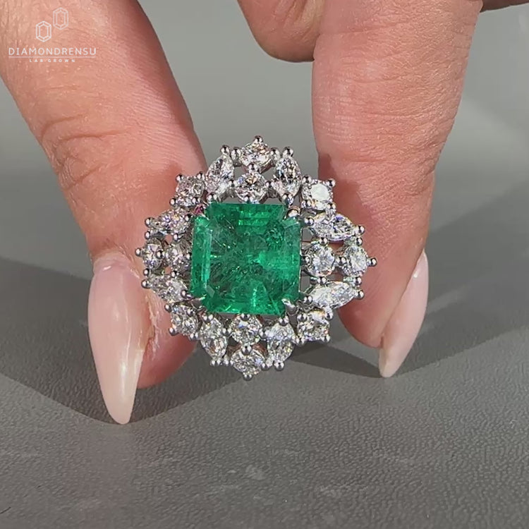 Asscher cut emerald ring nature cluster twisted shank set.
