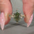 Nature inspired marquise ring with round cut side stones.