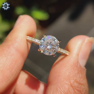 Handmade ring featuring a pave setting and classic round diamond design