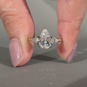 Pear diamond ring two kite stones three stone style.