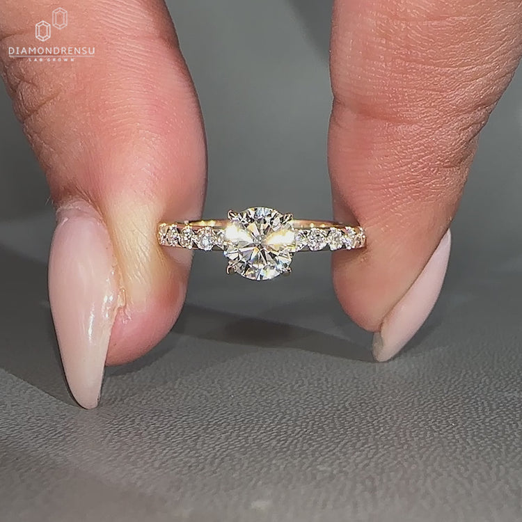 Handmade round diamond ring featuring a pave setting.
