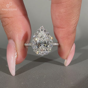 Pear diamond ring halo pave round diamond style.
