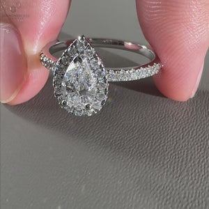 Handmade pear shaped halo ring in yellow gold.
