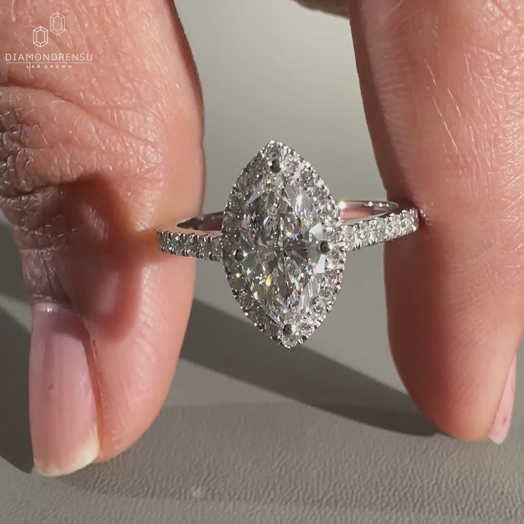 Marquise diamond ring with pave setting.
