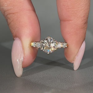 Round old cut ring with side stones five stone setting.
