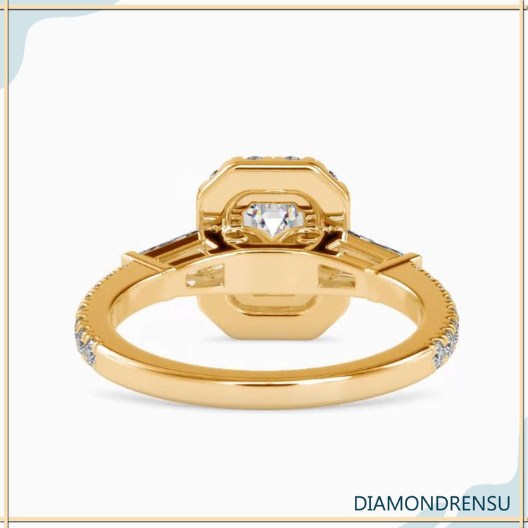 tapered baguette​ engagement ring setting with emerald cut diamond.