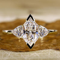 Dutch Marquise Engagement Ring with trillion engagement ring.
